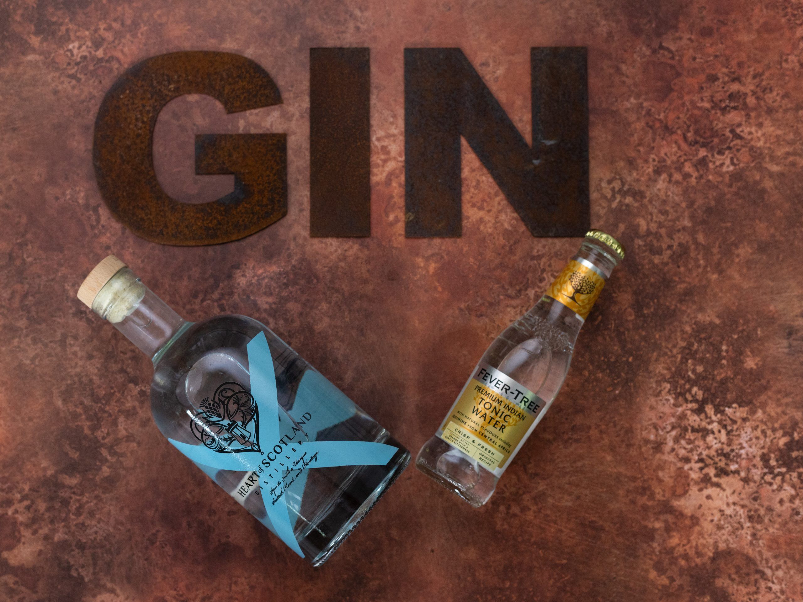 Heart of Scotland Gin with Fever-Tree Tonic on a rustic background, showcasing a premium Scottish G&T with handcrafted small-batch gin.