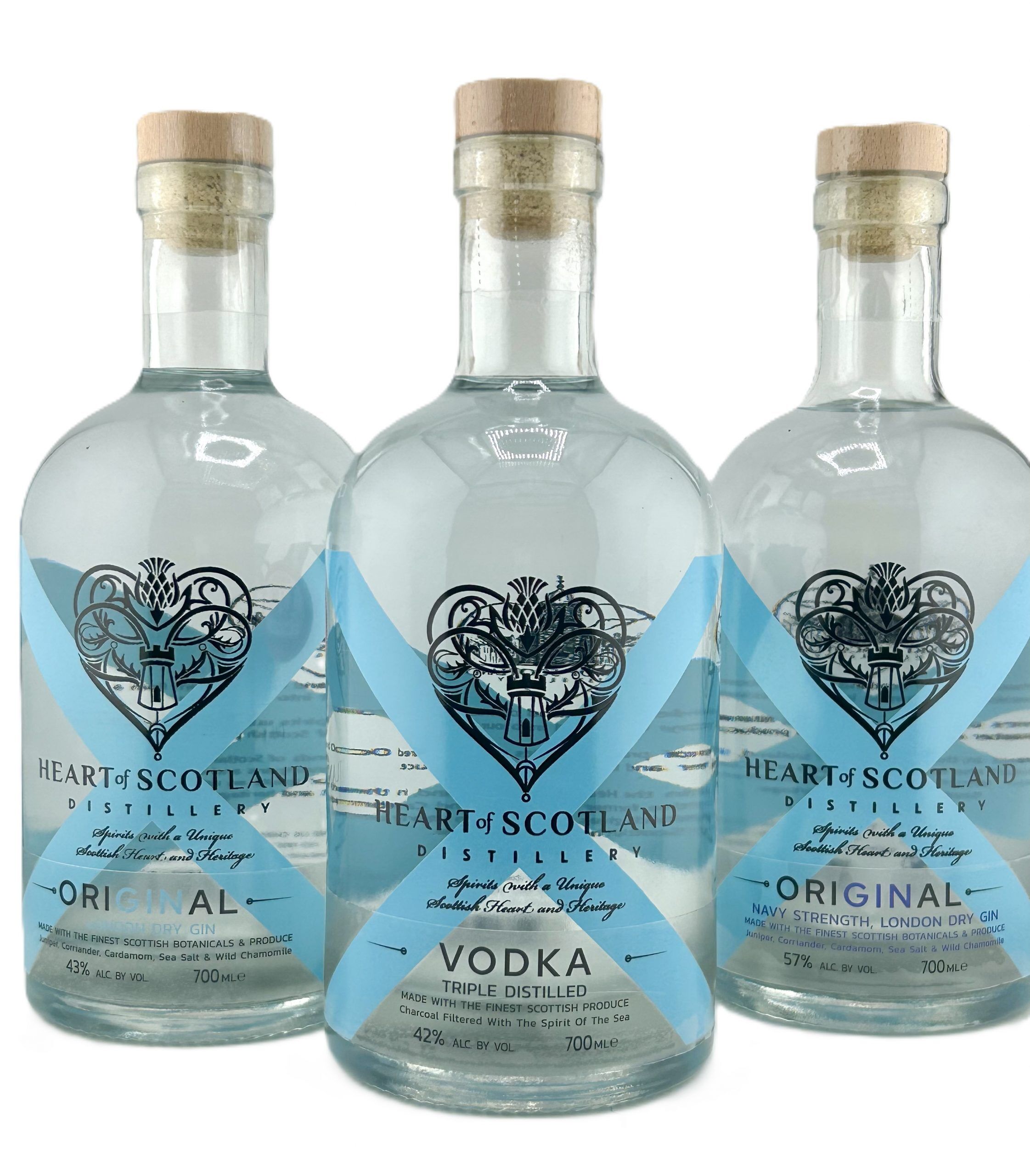 A trio of Heart of Scotland Distillery gin and vodka bottles, showcasing premium small-batch Scottish spirits crafted with foraged botanicals.
